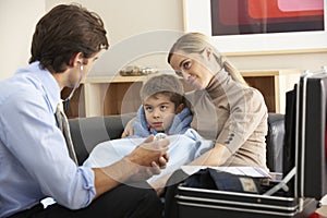 Doctor visiting sick child and mother at home