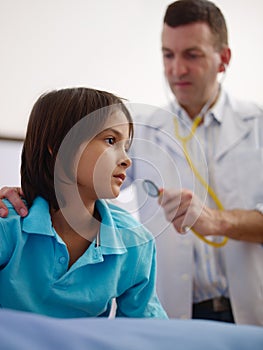 Doctor visiting sick young asian boy in hospital