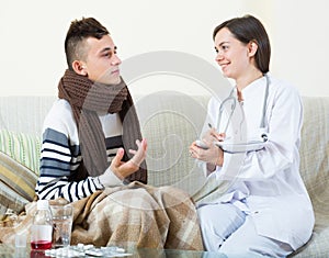 Doctor visiting teenager with cold at home