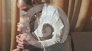 The doctor visits the baby patient at home. Happy Baby with stethoscope