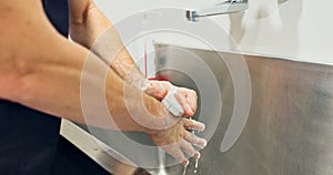Doctor, washing hands and soap by scrub for surgery for operation, hygiene and disease. Person, surgeon and closeup for
