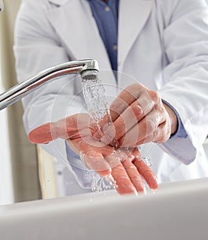 Doctor washing hands before work
