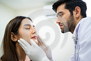 Doctor wear glove and check face skin condition before plastic surgery. Beautician touching woman face by hand. Cosmetic treatment
