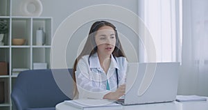 Doctor wear headset consult female patient make online webcam video call on laptop screen. Telemedicine videoconference