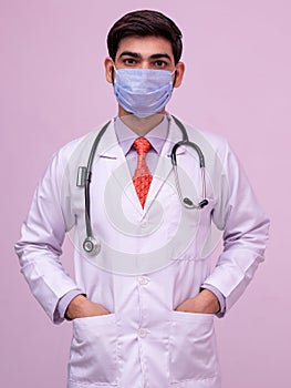 Doctor Wearing Medical Mask.  standing with both hands in pocket on isolated background