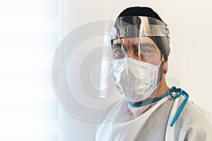 Doctor wearing ppe face surgical mask and visor fighting against corona virus outbreak