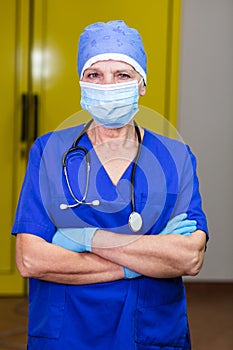 A doctor wearing protective accessories and a blue uniform