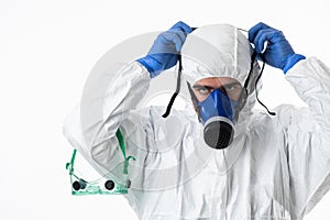 Doctor wearing protective biological suit and mask due to coronavirus 2019-nCoV global pandemic warning and danger