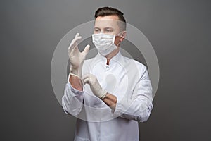 Doctor wearing protective latex gloves and face mask