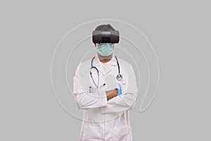 Doctor Wearing VR Glasses, Medical mask and Gloves Hands Grossed Isolated. Indian Man Doctor Online Medicine