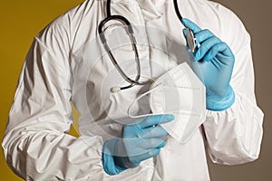 Doctor wearing a white overall, a stethoscope and nitrile gloves