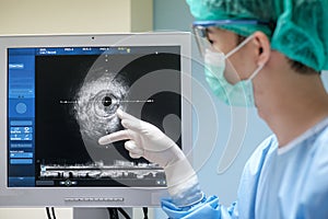 Doctor wears sterile uniform and uses Intravascular ultrasound imaging IVUS machine