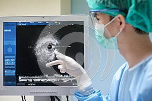Doctor wears sterile uniform and uses Intravascular ultrasound imaging IVUS machine photo