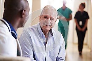 Doctor Welcoming To Senior Male Patient Being Admitted To Hospital photo