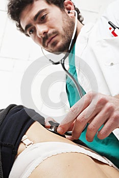 Doctor with white coat do back auscultation with stethoscope. photo