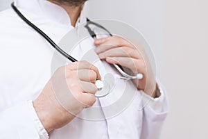 Doctor in a white coat with stethoscope, close up