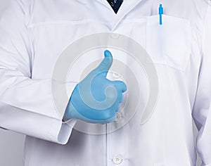 Doctor in a white coat and tie shows with his hand a gesture like