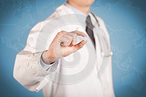 Doctor in white holding a pill