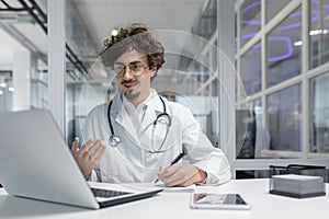 Doctor in White Lab Coat Using Laptop Computer