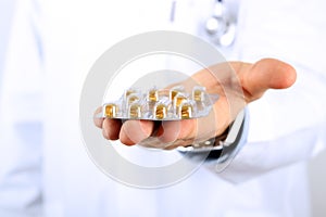 Doctor in a white labcoat giving pills photo