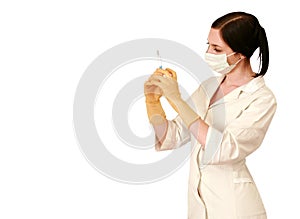 Doctor in a white robe and a mask with syringe