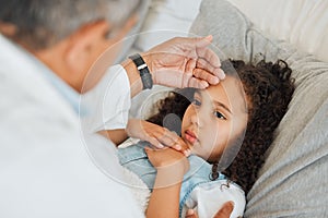 The doctor will know just what to do. Shot of an unrecognizable doctor checking a sick little girls temperature at home.