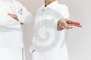 doctor wiping with a finger, space for interactive themes, female doctor in the background