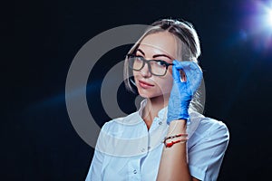 Doctor woman adjusts her glasses