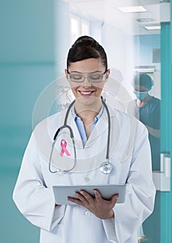 Doctor woman with breast cancer awareness ribbon