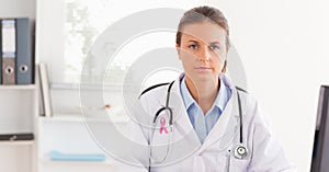 Doctor woman with breast cancer awareness ribbon