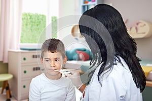 Doctor woman checking temperature to a child