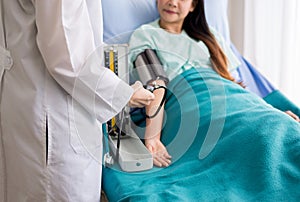 Doctor woman checking to her patient blood pressure in hospital,Heart rate pressure gauge