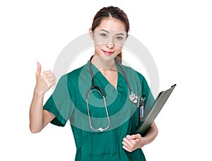 Doctor woman with clipboard and thumb up