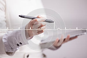 Doctor woman drawing cardiogram