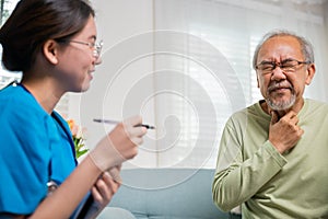 Doctor woman examines lymph nodes on elderly neck to determine if swollen