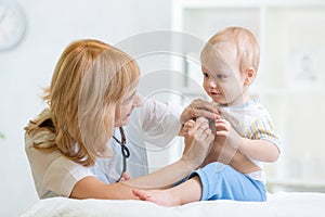 Doctor woman examining child boy with stethoscope