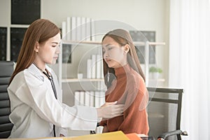 Doctor woman examining her patient breast for cancer.