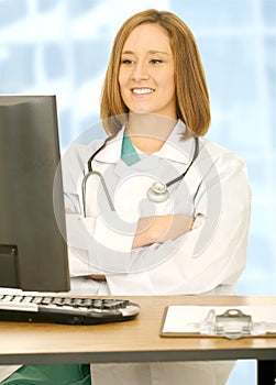 Doctor Woman Folding Hand And Watching Computer Sc