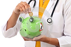 Doctor woman holding a piggy bank
