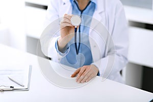 Doctor woman holds stethoscope head close-up. Physician ready to examine and help patient. Medical best treatment