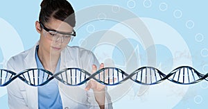 Doctor woman interacting with 3D DNA strand