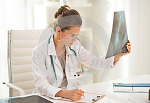 Doctor woman looking on fluorography photo