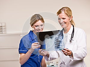 Doctor and woman looking at x-ray