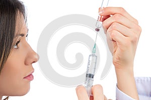 Doctor woman with medical syringe with needle