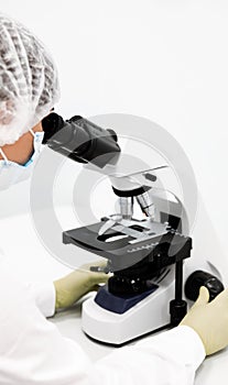 Doctor woman with microscope in laboratory. Scientific research