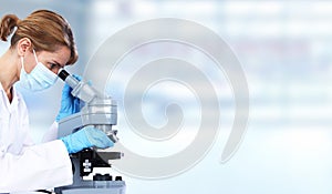 Doctor woman with microscope. photo