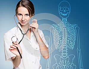 Doctor woman pointing on drawing human skeleton.