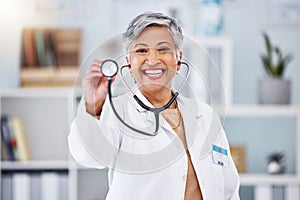 Doctor, woman and portrait with stethoscope for heartbeat, healthcare services or cardiology. Happy mature medical