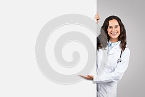 Doctor woman presenting behind blank white board