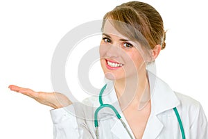 Doctor woman presenting something on empty hand